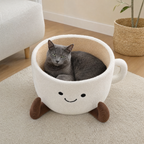 BelleVie CupNest with a grey cat relaxing inside in a bright neutral living room